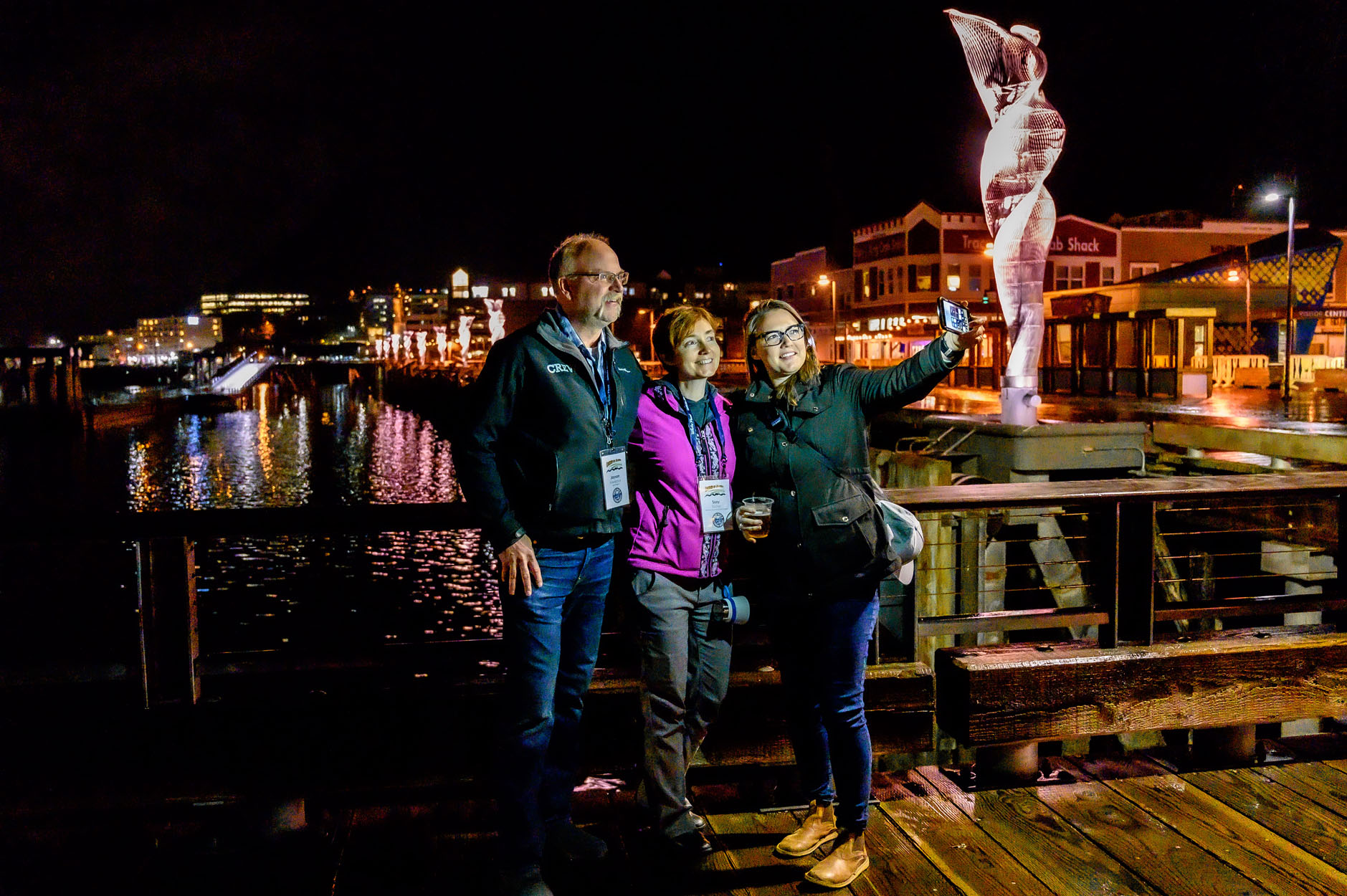 Members taking pictures together over the Alaska night skyline