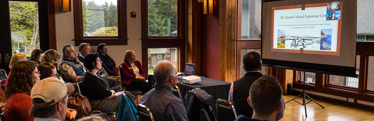 Members in conference room viewing presentation on screen at the ATIA Annual Convention