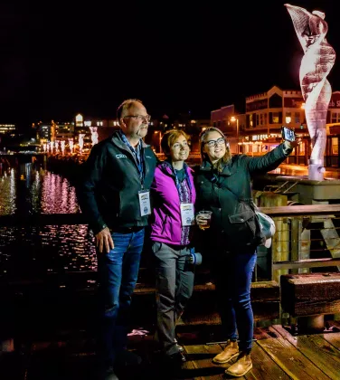 Members taking pictures together over the Alaska night skyline